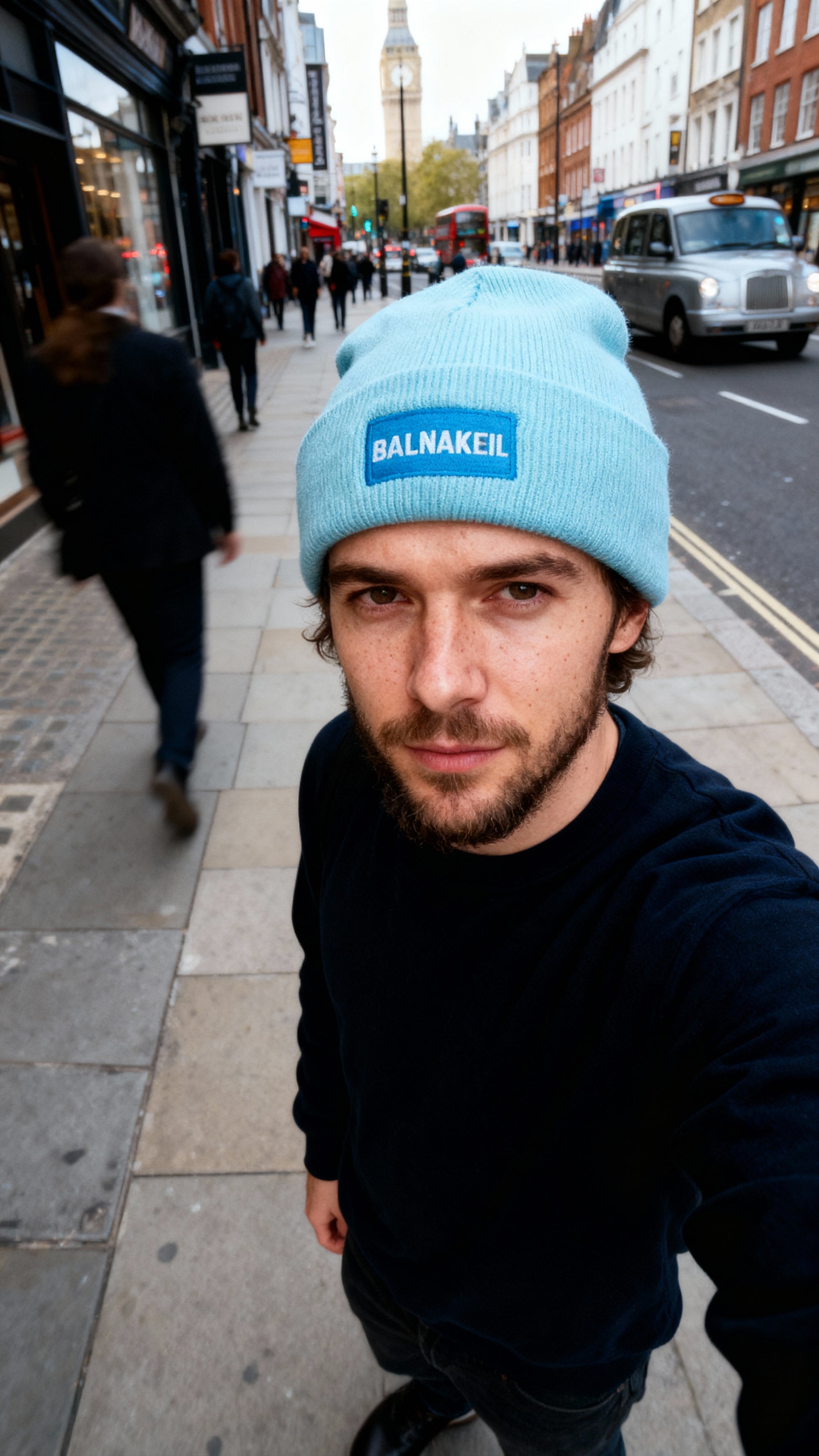 man wearing mint green beanie on a London street.